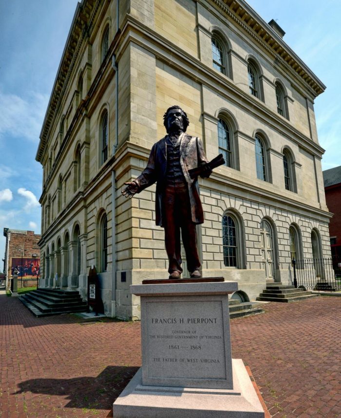 The first West Virginia state capitol was the 1859 Linsly Institute building in Wheeling, serving from June 20, 1863, to April 1, 1870. The building, still a Wheeling landmark, combines the Greek Revival and Italianate architectural styles. 
Additionally, the statue is of Francis H. Pierpont, a key state of West Virginia founder and was the first and only governor of the Reorganized Government of Virginia. In his retirement Pierpont helped to found the West Virginia Historical Society and served as president of the General Conference of the Methodist Protestant Church.