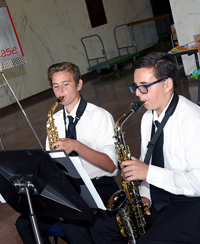 Two high school students playing saxophone